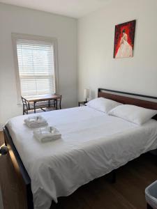 a bedroom with a large bed with two towels on it at Boston Historic Lower Mills in Boston