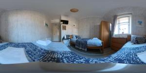 a bedroom with two beds and a window at Dalmore Lodge Guest House in Edinburgh