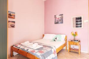 a small bedroom with a bed and a table at Workation Studio by the Sea in Velika
