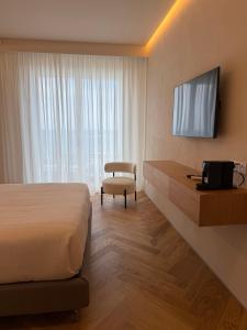 a hotel room with a bed and a television at Rumare - BADIA NUOVA in Trapani +30 photos