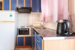 a small kitchen with a sink and a microwave at Workation Studio by the Sea in Velika