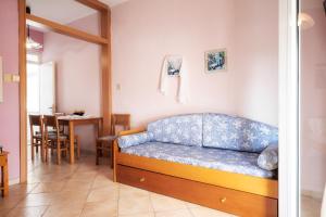 a living room with a blue couch and a table at Workation Studio by the Sea in Velika