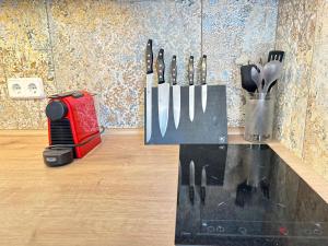 a knife block with knives and utensils on a counter at Cas Quinto in Cala Ratjada