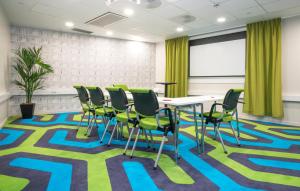 a conference room with a table and chairs on a rug at Thon Hotel Rosenkrantz Oslo in Oslo