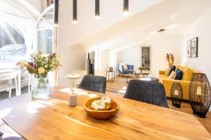 a living room with a wooden table and a couch at Villa Fabiola in Strandnähe in Binz