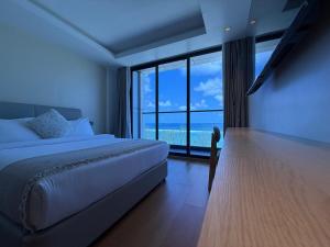 a bedroom with a bed and a large window at Sunny Canopy in Hulhumale