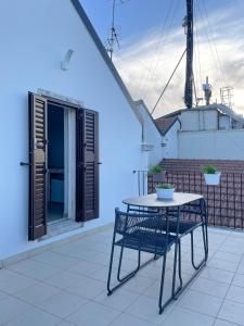 a table and a chair on a balcony with a building at L'Armonia - "La Terrazza" in Noci +30 photos
