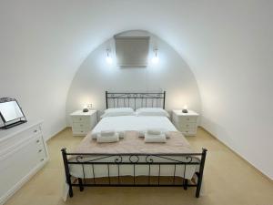 a bedroom with a large bed with two night stands at L'Armonia - "La Terrazza" in Noci