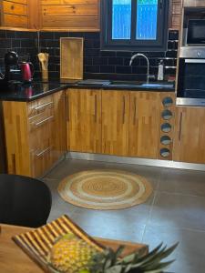 a kitchen with a sink and a rug on the floor at Le Bananawi in Pointe-Noire +29 photos
