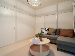a living room with a couch and a table at Kanigaya House in Kawasaki