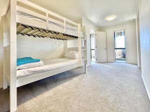 a bedroom with bunk beds in a house at Spectacular Woolleys Bay in Matapouri