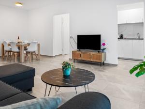 a living room with a tv and a table at Appartamento Rivamaggia Locarno in Solduno