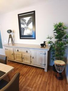 a room with a dresser with a mirror and a plant at Mazzity 2 in Antwerp