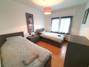 a bedroom with two beds and a window at Mazzity 2 in Antwerp