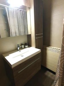 a bathroom with a white sink and a mirror at Mazzity 2 in Antwerp