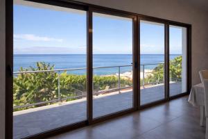 a room with a view of the ocean at Villa O Pomar with optional heated pool in Paul do Mar