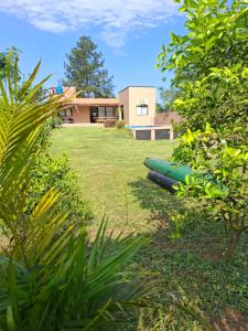 a yard with two green pipes in the grass at Casa El Bosque in Candelaria