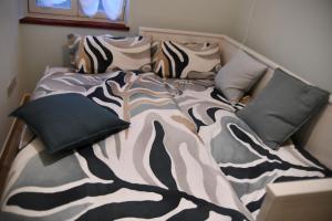 a bed with pillows on it in a room at Casa Broglia in Castel Santa Maria