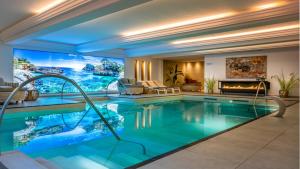 a swimming pool in a house with a fireplace at Ferienwohnung 211 Salinenparc Design Budget Hotel in Erwitte
