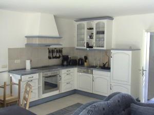 a kitchen with white cabinets and a stove at Himmelblau in Dabitz