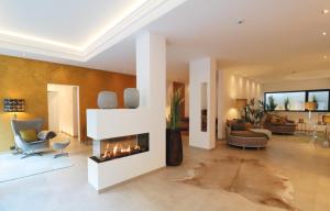a living room with a fireplace in the middle at Ferienwohnung 210 Salinenparc Design Budget Hotel in Erwitte