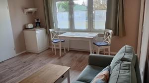 a living room with a couch and a table at Ferienwohnung Wulkow in Großwulkow