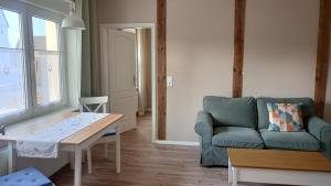a living room with a couch and a table at Ferienwohnung Wulkow in Großwulkow
