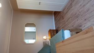 a room with a staircase with a mirror and a window at Ferienwohnung Wulkow in Großwulkow +4 photos