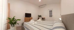 a bedroom with a bed with towels on it at Cinghiale Bianco in Cagliari