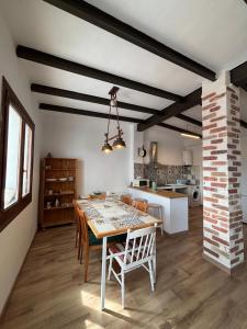 a kitchen and dining room with a table and chairs at Les Coves de Lluna in Vall de Uxó +23 photos