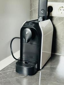 a black computer printer sitting on top of a counter at Apartament UNO in Reşiţa
