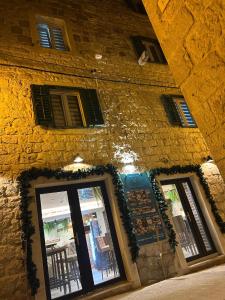 a brick building with windows and a door at Villa Nautica Stone House in Split +52 photos