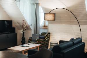 a living room with a couch and chairs and a table at LaVida LakeSoul Cozy Retreat in Murten am See & Altstadt, free parking in Murten