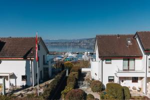 a view of a harbor between two houses at LaVida LakeSoul Cozy Retreat in Murten am See & Altstadt, free parking in Murten