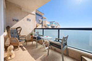 a balcony with chairs and a table with a view at Panoramic Sea View Cabo Roig in Orihuela Costa