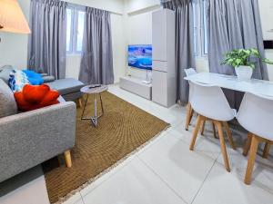a living room with a couch and a table at Sunny Canopy in Hulhumale