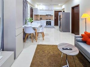 a living room and kitchen with a couch and a table at Sunny Canopy in Hulhumale +117 photos