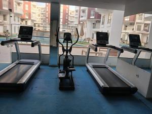 a gym with three treadmills in front of a window at Aqua Palms Resort D101 in El Gouna