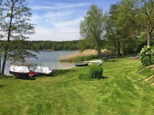 a group of boats parked on the shore of a lake at Bungalow in Klein Labenz for 4 Personen in Klein Labenz