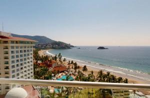 a view of the beach from the balcony of a resort at Sunscape Dorado Pacifico Ixtapa Resort & Spa- All Inclusive in Ixtapa