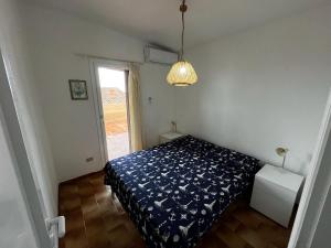 a small bedroom with a bed and a window at Casa Vacanza con Piscina e Accesso diretto al Mare in Santa Marinella