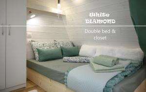 a bed with pillows on it in a room at White DIAMOND in Chalkidiki in Vergia