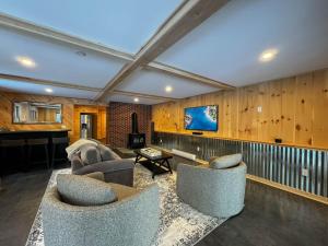 a living room with two couches and a tv at Long Lake-Lake Front - in Bridgton