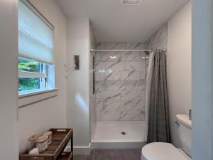 a bathroom with a shower and a toilet at Long Lake-Lake Front - in Bridgton +85 photos