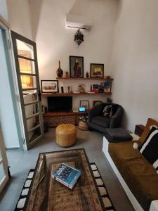 a living room with a couch and a table at La Maison des Amis in Fez