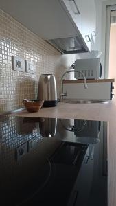 a kitchen counter with a sink and a microwave at Casa PERLAMARE in Otranto