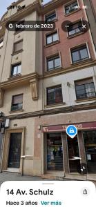 a building with a sign in front of it at Soleado - En el centro de Gijón in Gijón