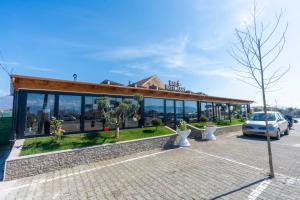 a building with a car parked in front of it at Guesthouse 3 Diamonds in Omarë