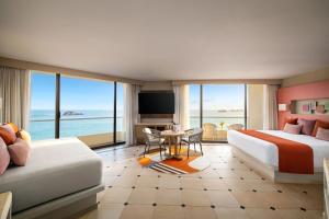 a hotel room with a bed and a view of the ocean at Sunscape Dorado Pacifico Ixtapa Resort & Spa- All Inclusive in Ixtapa