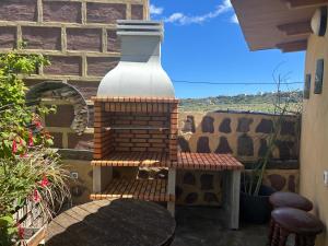 a large vase sitting on a table on a patio at Villa Canaria piscina jacuzzi jardín in Santa Maria de Guia de Gran Canaria